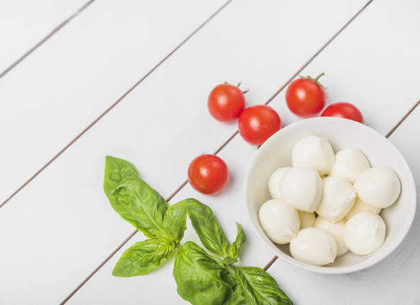mozzarella-cheese-ball-with-basil-leaf-and-red-tomatoes-on-wooden-white-background_kl_(1).jpg